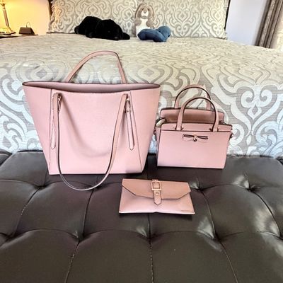 Sale Photo Thumbnail #306: Set of three matching blush pink leather accessories, including a large tote bag, a smaller satchel with a bow detail, and a fold-over clutch wallet.