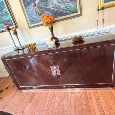 Sale Photo Thumbnail #109: Contemporary high-gloss dark wood sideboard with silver metallic hardware and trim.