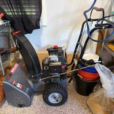 Sale Photo Thumbnail #72: Craftsman 22-inch gas-powered snow blower featuring a black and gray frame with deep-tread tires.