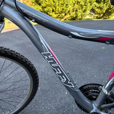Sale Photo Thumbnail #52: Huffy Scout mountain bike featuring a metallic gray frame with pink and white decals.