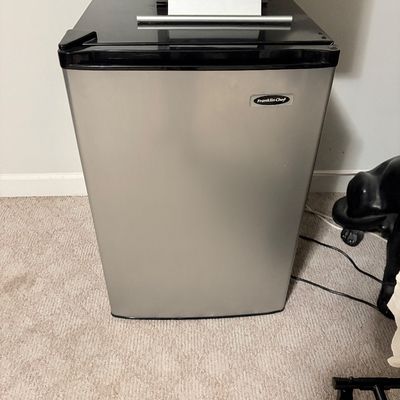 Sale Photo Thumbnail #179: Compact Franklin Chef mini refrigerator with a stainless steel face and black body, shown with a Dell monitor sitting on top.