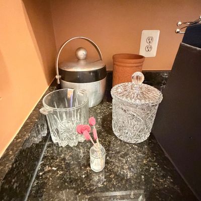 Sale Photo Thumbnail #106: Collection of vintage barware accessories including a mid-century aluminum West Bend ice bucket, clear cut-glass ice buckets, and decorative pink drink stirrers.