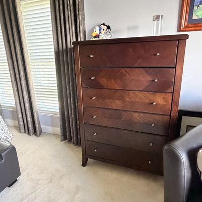 Sale Photo Thumbnail #311: Contemporary dark wood tall chest of six drawers featuring a geometric chevron veneer pattern and silver knobs.