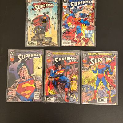 Group of five bagged 1990s DC Superman comic books, including Action Comics and The Man of Steel issues.