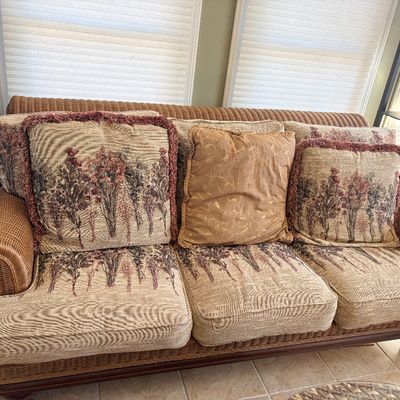 Sale Photo Thumbnail #150: Wicker sofa with floral tapestry upholstery, rolled arms, and coordinating accent pillows.
