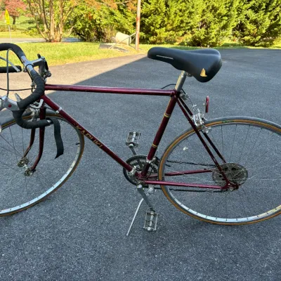 Sale Photo Thumbnail #51: Vintage Kabuki 10-speed road bike in maroon, featuring drop handlebars and a replacement Mongoose saddle.