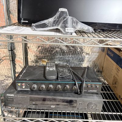 Sale Photo Thumbnail #207: Collection of home A/V equipment on wire shelving, including a Philips DVD player, a Vidicraft video enhancer with remotes, a Toshiba flat-screen monitor, and a Denon box.