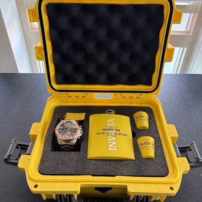 Invicta collector's set presented in a bright yellow protective impact case, complete with a rose gold-tone chronograph wristwatch,...