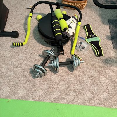 Sale Photo Thumbnail #257: Home exercise equipment set featuring an Ab Doer trainer with neon yellow padded handles, a pair of chrome adjustable dumbbells, and fitness accessories.