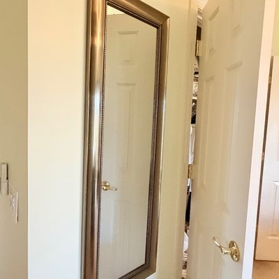 Sale Photo Thumbnail #287: Tall full-length wall mirror featuring a bevel-edged metallic bronze frame with beaded inner trim.
