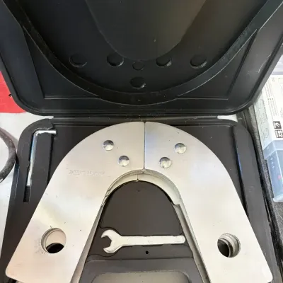 Sale Photo Thumbnail #38: Corner clamping jig set with metal guide plates and wrenches, housed in a molded black hard plastic storage case.