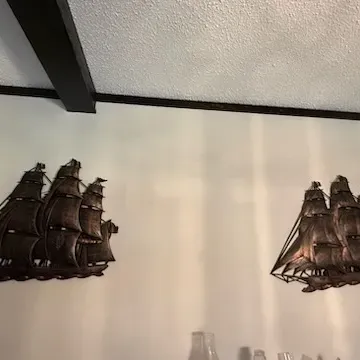 Sale Photo Thumbnail #44: Pair of vintage copper-toned metal sailing ship wall art sculptures in detailed three-dimensional designs.