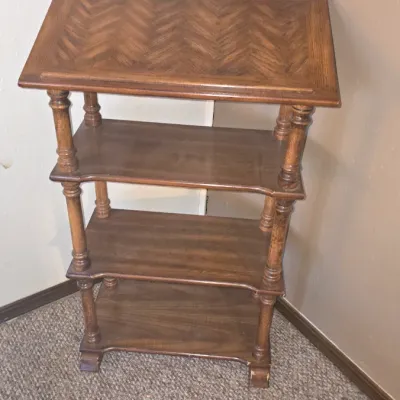 Sale Photo Thumbnail #66: Vintage four-tier wooden shelf unit featuring turned spindles and a sloped, herringbone-patterned top surface.