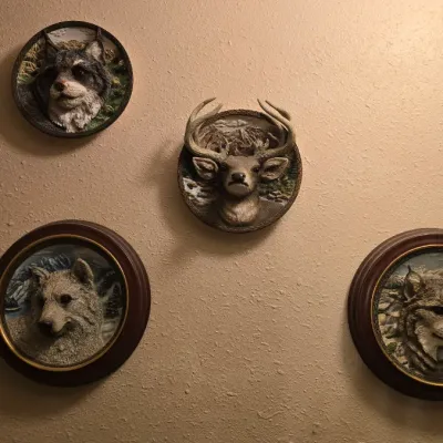 Sale Photo Thumbnail #23: Collection of five vintage 3D resin wildlife wall plaques featuring detailed animal busts, including a mountain goat, wolf, deer, and lynx.