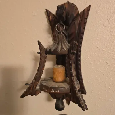 Sale Photo Thumbnail #4: Hand-carved dark wood hanging candle sconce with detailed trim and 'Avila' inscribed on the base.