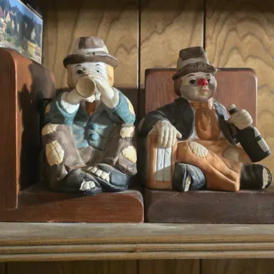 Sale Photo Thumbnail #65: Pair of vintage hobo clown bookends featuring hand-painted ceramic figures mounted on wooden bases.