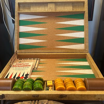 Sale Photo Thumbnail #105: Vintage backgammon game set in a tweed carrying case, complete with green and yellow play checkers, dice, leather shakers, and an instruction booklet.