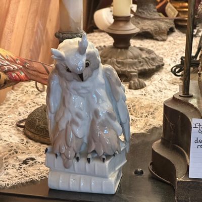 Sale Photo Thumbnail #55: Glazed porcelain owl figurine perched on a stack of books, featuring detailed feather textures in muted gray and white tones.