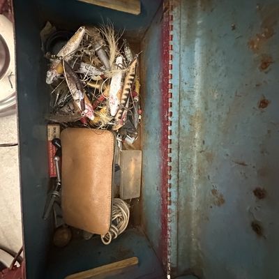 Sale Photo Thumbnail #67: Vintage blue metal tackle box filled with assorted vintage fishing lures, a leather pouch, and fishing tackle.