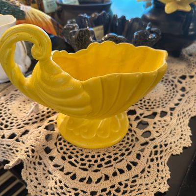 Sale Photo Thumbnail #57: Vintage bright yellow pottery swan-shaped planter or dish, featuring a scalloped rim and scrolled neck detail.