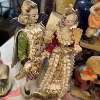 Sale Photo Thumbnail #58: Vintage porcelain figurine set depicting a courtly couple in ornate 18th-century style attire with gilded trim accents.
