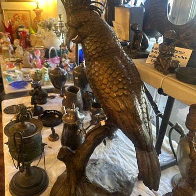 Sale Photo Thumbnail #92: Large bronze statue of a cockatoo perched on a branch, featuring detailed feather textures and a solid base.