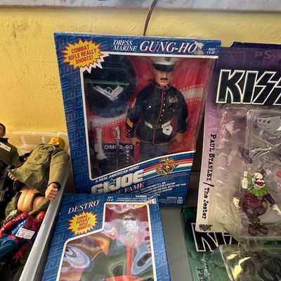 Sale Photo Thumbnail #49: Vintage 12-inch G.I. Joe Hall of Fame figures in original packaging, including Dress Marine Gung-Ho and Destro, displayed alongside McFadden KISS action figures.