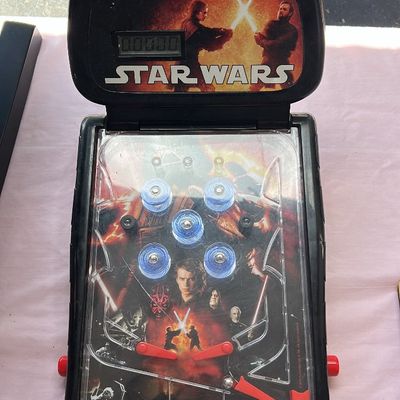 Sale Photo Thumbnail #64: Vintage Star Wars Episode III: Revenge of the Sith tabletop electronic pinball game. Features an LCD score display and graphics of Anakin Skywalker and Obi-Wan Kenobi, circa 2005.