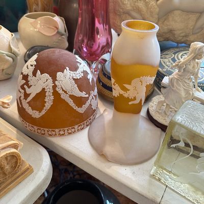 Sale Photo Thumbnail #63: A collection of art glass items, featuring an amber frosted glass shade and matching vase adorned with white relief cherub motifs in the cameo style.