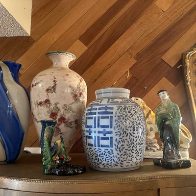 Sale Photo Thumbnail #101: Collection of decorative Asian and vintage ceramic art pieces, including a blue-and-white swirl glass vase, a floral vase, a Chinese double happiness ginger jar, and a geisha figurine.