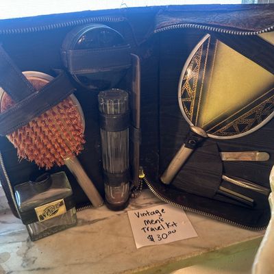 Sale Photo Thumbnail #72: Vintage men's travel grooming kit in a zippered leather case, including brushes, a hand mirror, glass bottles, and grooming tools.