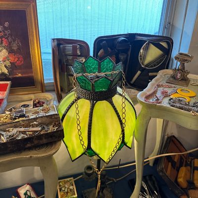 Sale Photo Thumbnail #6: Vintage green slag glass tulip-style table lamp displayed alongside small side tables and assorted costume jewelry.