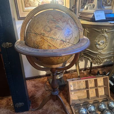 Sale Photo Thumbnail #94: Vintage Italian style floor-standing globe lamp on a turned wooden tripod stand, paired alongside a wooden box of petanque bocce balls.