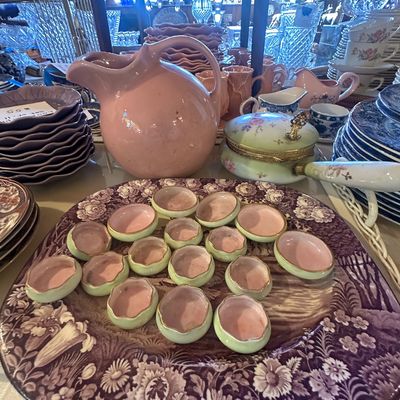 Sale Photo Thumbnail #112: Vintage ceramic and porcelain tabletop collection featuring a large pink pitcher, small green and pink salt cellars, and a purple floral transferware platter.