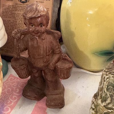 Sale Photo Thumbnail #36: Vintage painted cast metal figurine of a boy carrying water buckets with a shoulder yoke.