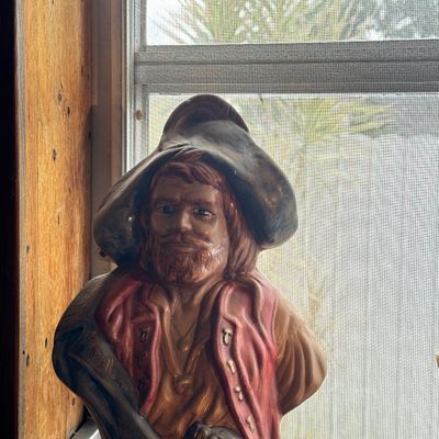 Sale Photo Thumbnail #28: Vintage ceramic pirate bust featuring a painted red vest, tricorne hat, and flintlock pistol.