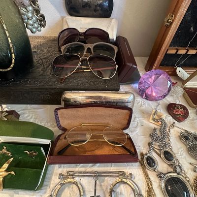 Sale Photo Thumbnail #66: Collection of vintage eyeglasses and sunglasses displayed alongside various jewelry pieces, cases, and decorative items.