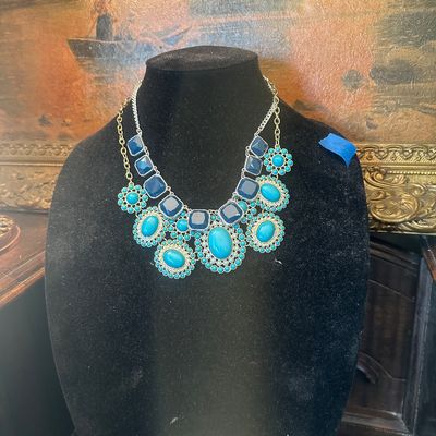 Sale Photo Thumbnail #75: Contemporary statement necklace featuring layered silver-tone chains with faux turquoise cabochons and deep blue square acrylic stones.