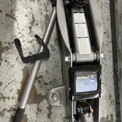 Sale Photo Thumbnail #42: DieHard heavy-duty hydraulic floor jack with pump handle, showing minor wear from use.