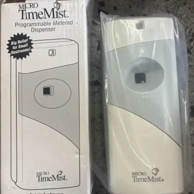Sale Photo Thumbnail #147: Micro TimeMist programmable metered aerosol dispenser, brand new in its original box and plastic wrap packaging.