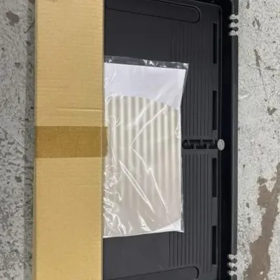 Sale Photo Thumbnail #88: Black plastic sliding under-desk keyboard or storage tray, accompanied by hardware boxed in cardboard and a manual in plastic packaging.