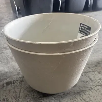 Sale Photo Thumbnail #43: Stacked pair of contemporary beige plastic planter pots featuring a textured outer finish and smooth white interiors.