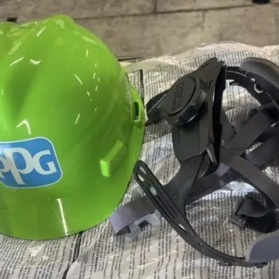 Sale Photo Thumbnail #23: Bright green PPG branded MSA hard hat shell alongside an unattached adjustable suspension harness, in like-new condition.