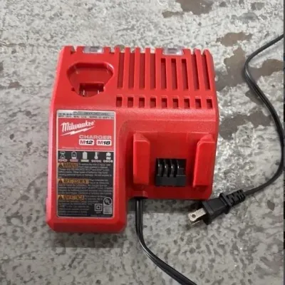 Sale Photo Thumbnail #95: Milwaukee M12 and M18 multi-voltage battery charger in red plastic casing.