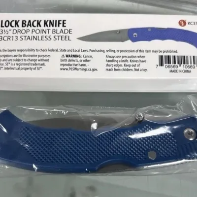 Sale Photo Thumbnail #75: SE brand lock back folding knife with a blue textured handle, shown in its original plastic packaging alongside its retail box.