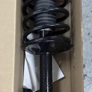 Sale Photo Thumbnail #60: New automotive complete strut and coil spring assembly, unused and packaged inside its original cardboard box.