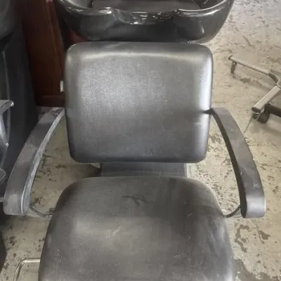 Sale Photo Thumbnail #67: Black vinyl salon shampoo chair with integrated tilting sink basin and chrome fixtures, showing light surface wear.