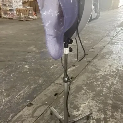 Sale Photo Thumbnail #39: Professional freestanding hair dryer or steamer featuring a purple tinted visor, adjustable height metal pole, and a rolling five-star caster base.