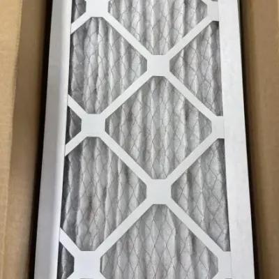 Sale Photo Thumbnail #73: Unused pleated HVAC air filter with wire mesh backing in a cardboard shipping box.