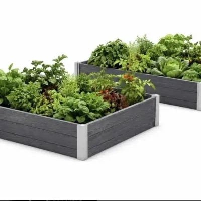 Sale Photo Thumbnail #35: Pair of modern composite wood elevated raised garden beds with corner bracket reinforcement, filled with lush vegetable and herb plantings.